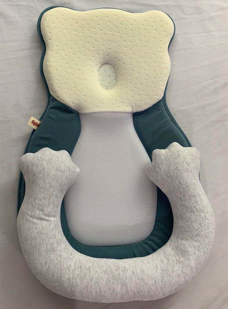 baby sleeping in soft baby lounger travel bed