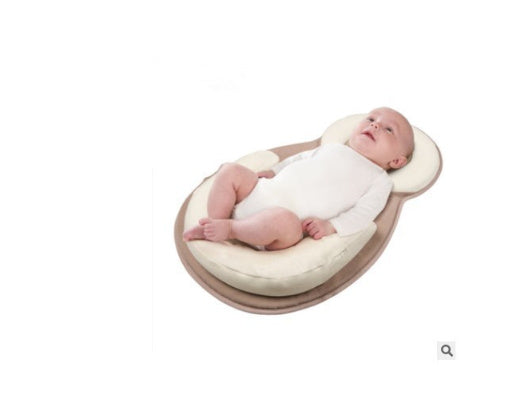 baby sleeping in soft baby lounger travel bed
