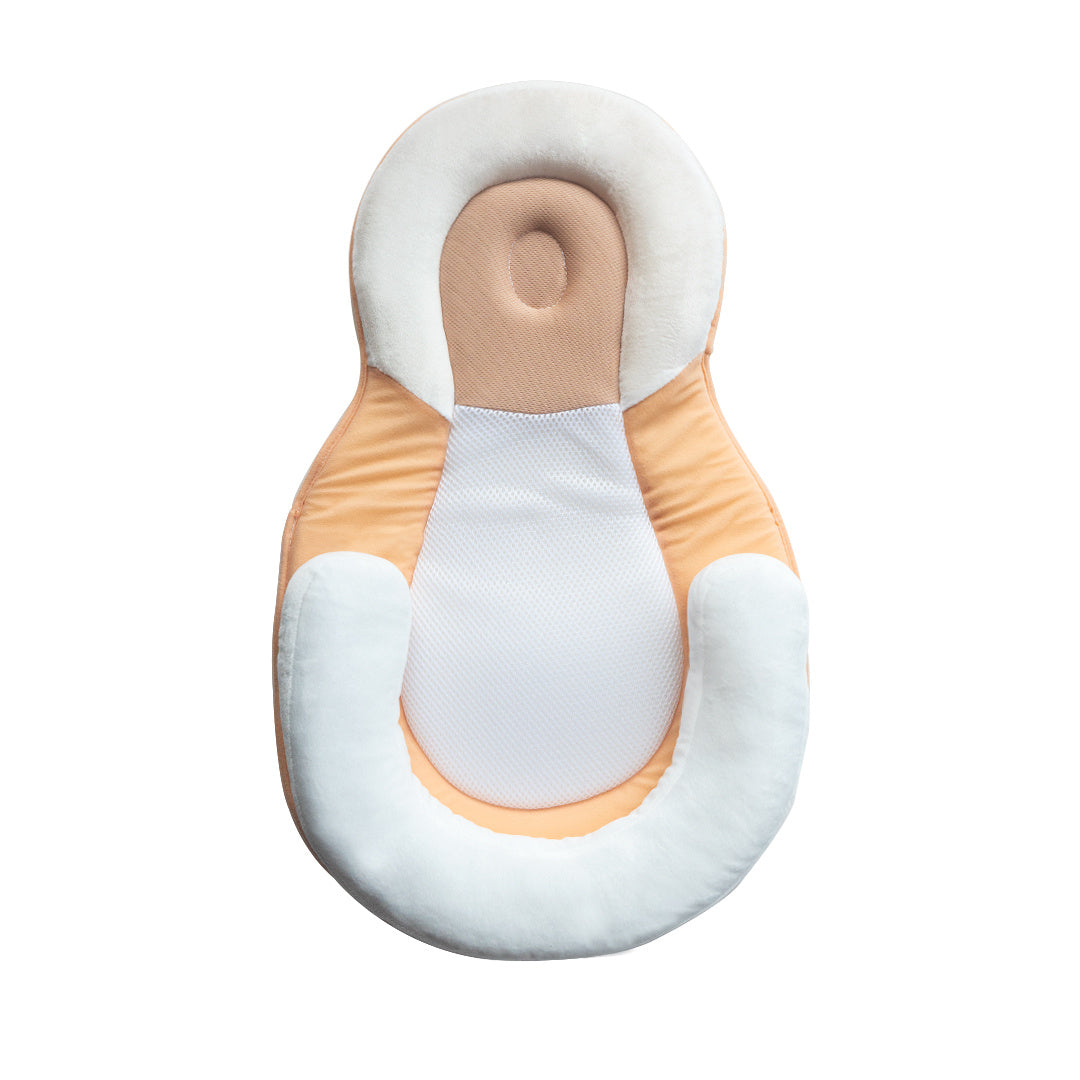 baby sleeping in soft baby lounger travel bed