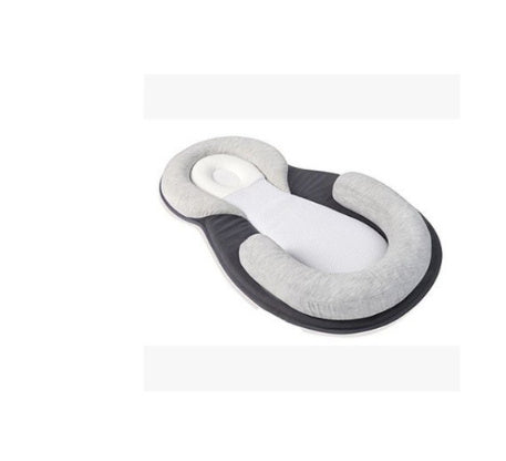 baby sleeping in soft baby lounger travel bed