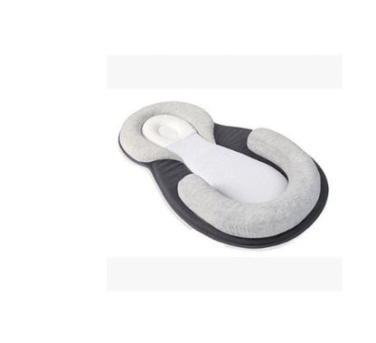 baby sleeping in soft baby lounger travel bed