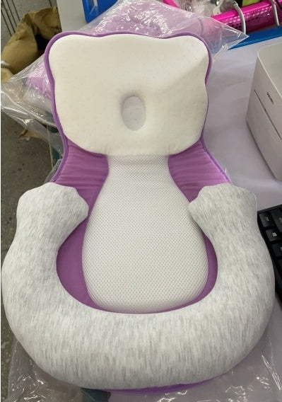 baby sleeping in soft baby lounger travel bed