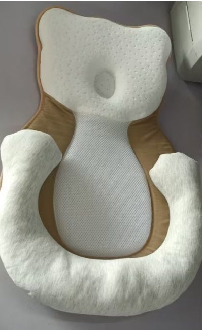 baby sleeping in soft baby lounger travel bed