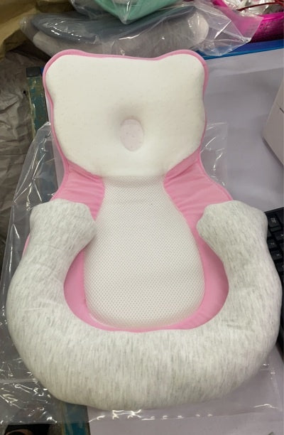 baby sleeping in soft baby lounger travel bed