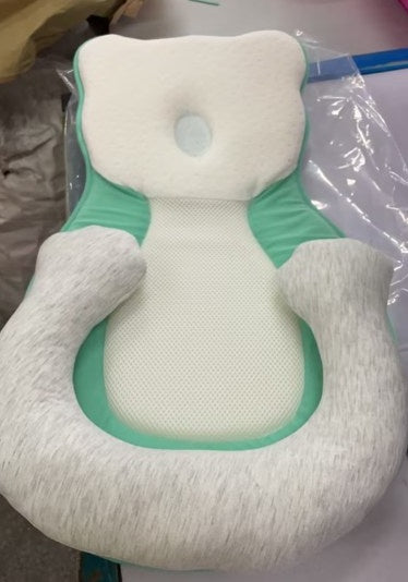 baby sleeping in soft baby lounger travel bed