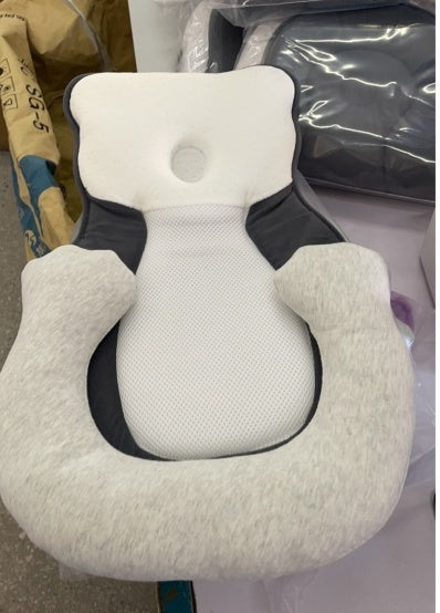 baby sleeping in soft baby lounger travel bed