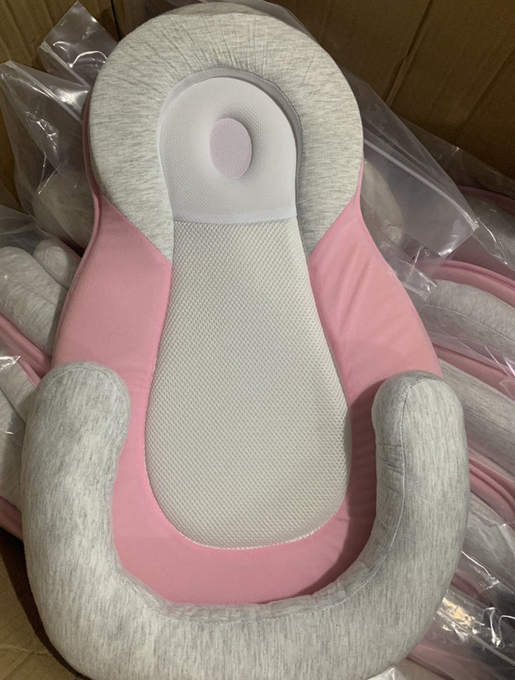 baby sleeping in soft baby lounger travel bed